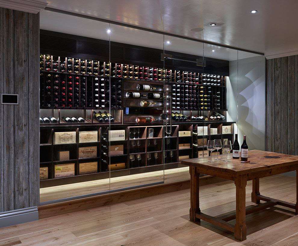 stylish wine cellar with glass panels and a huge collection